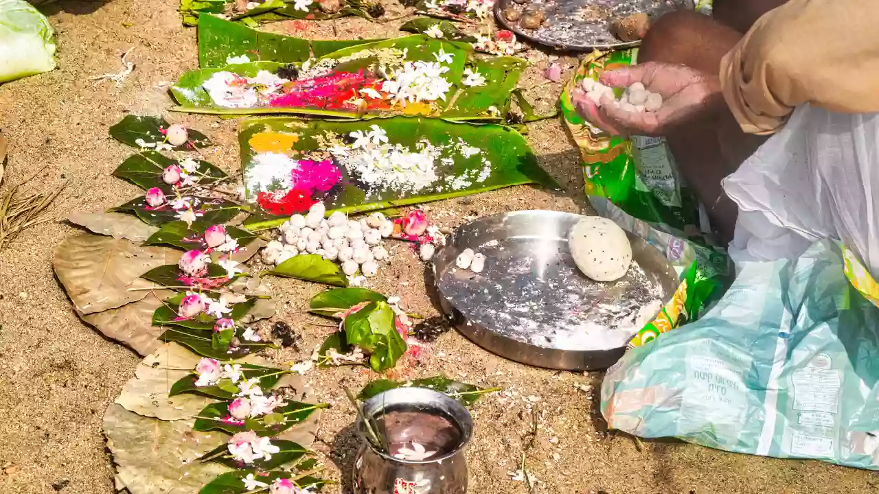 A person offering Pindas during Pinda Daan-The 3 Pillars of Pitrupaksha