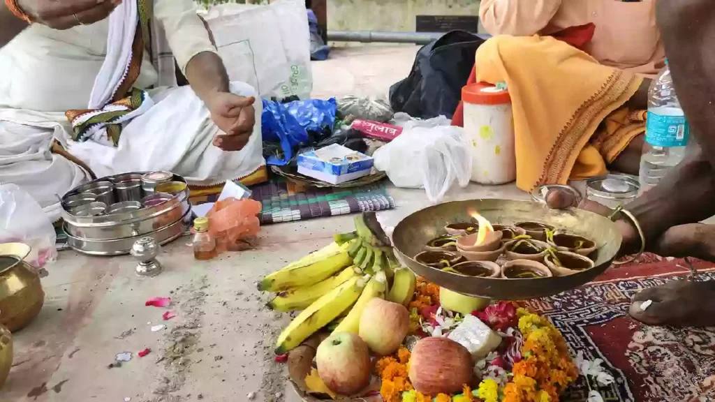 picture of a person siting near the ghat and doing ritual for there ancester's on the day of Pitrupaksha Navami Tithi