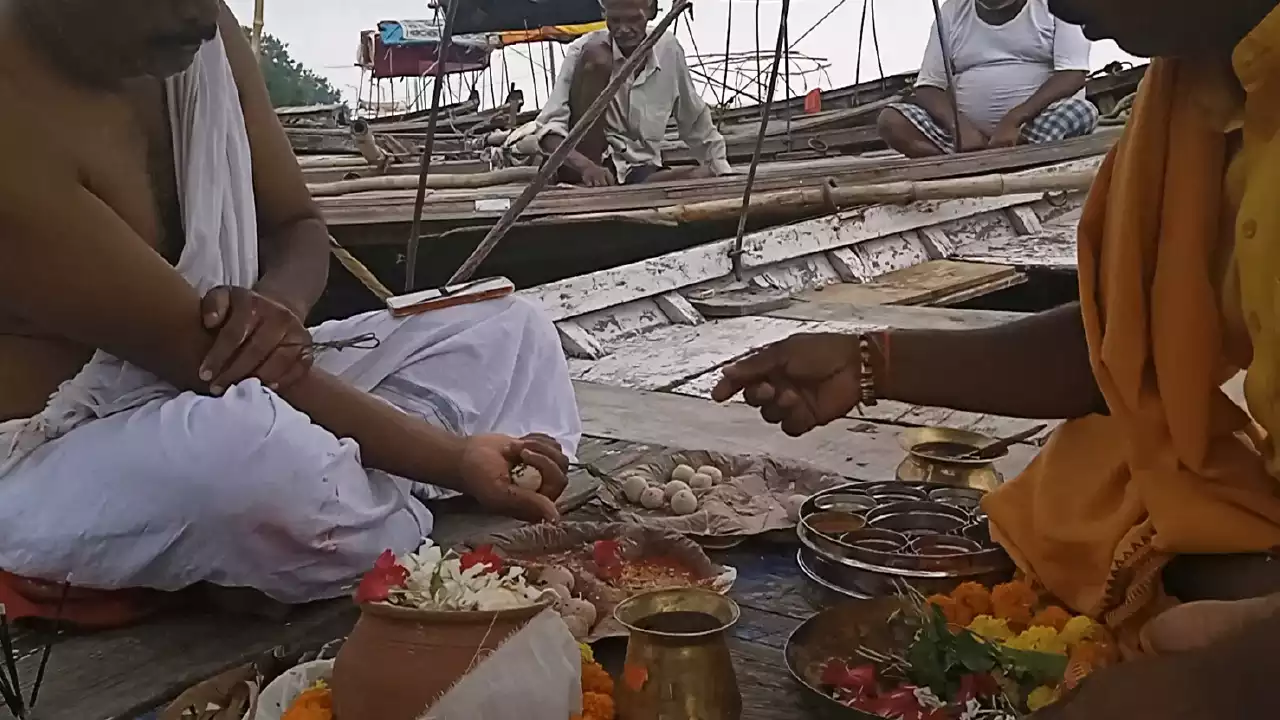 Photo of a person giving pindas to his ancestors-Pitrupaksha and Nitya Karma