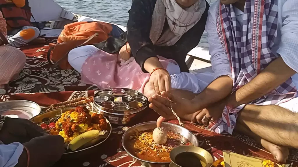 Image of couple doing ritual- offer food to ancestors- Food connects ancestors